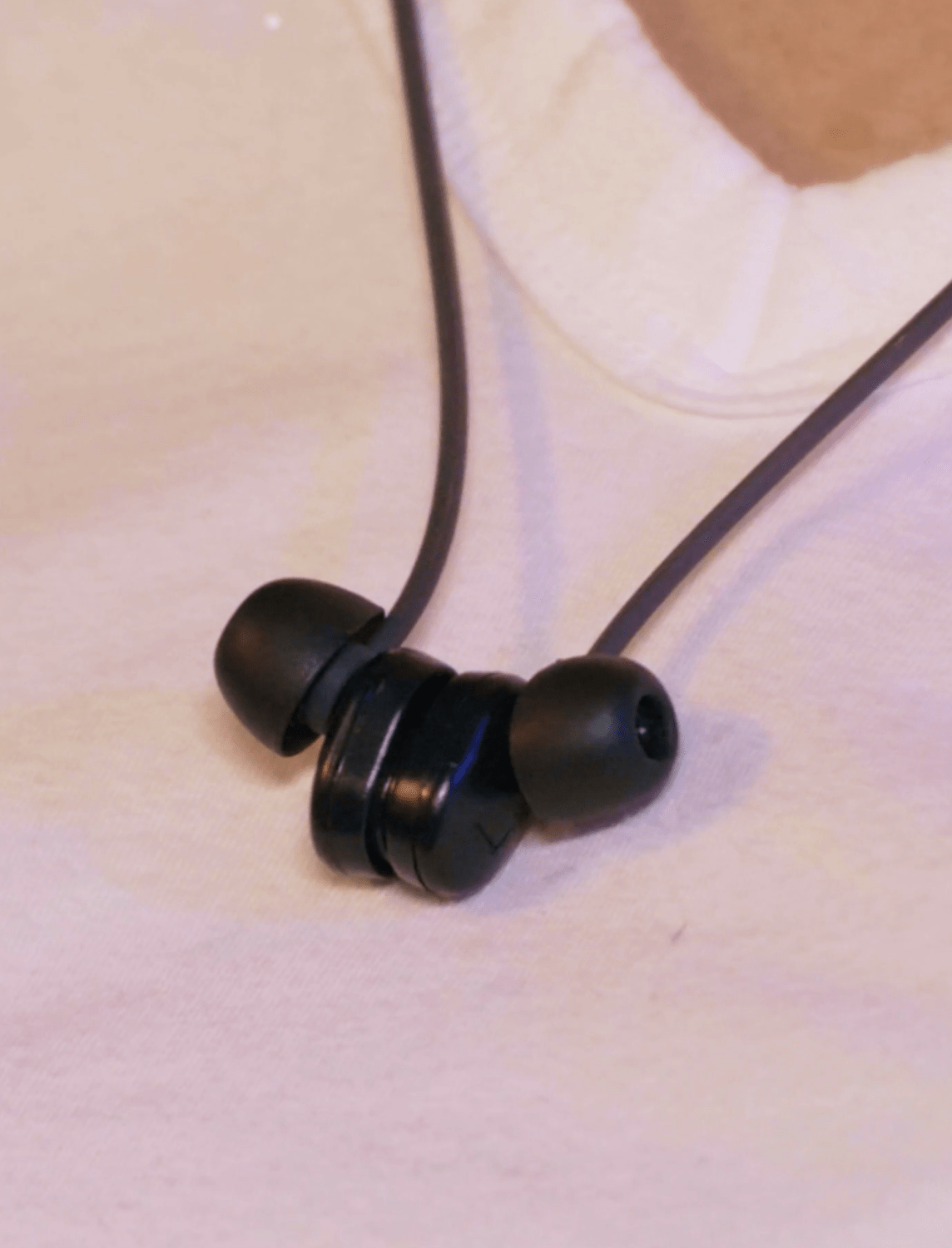 ear plugs clasped around neck