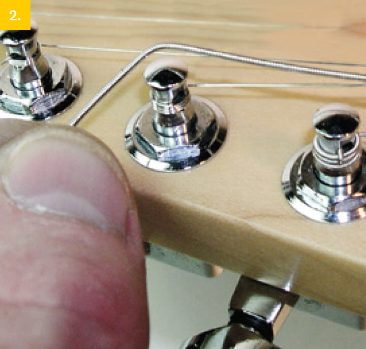 pulling guitar string across fretboard