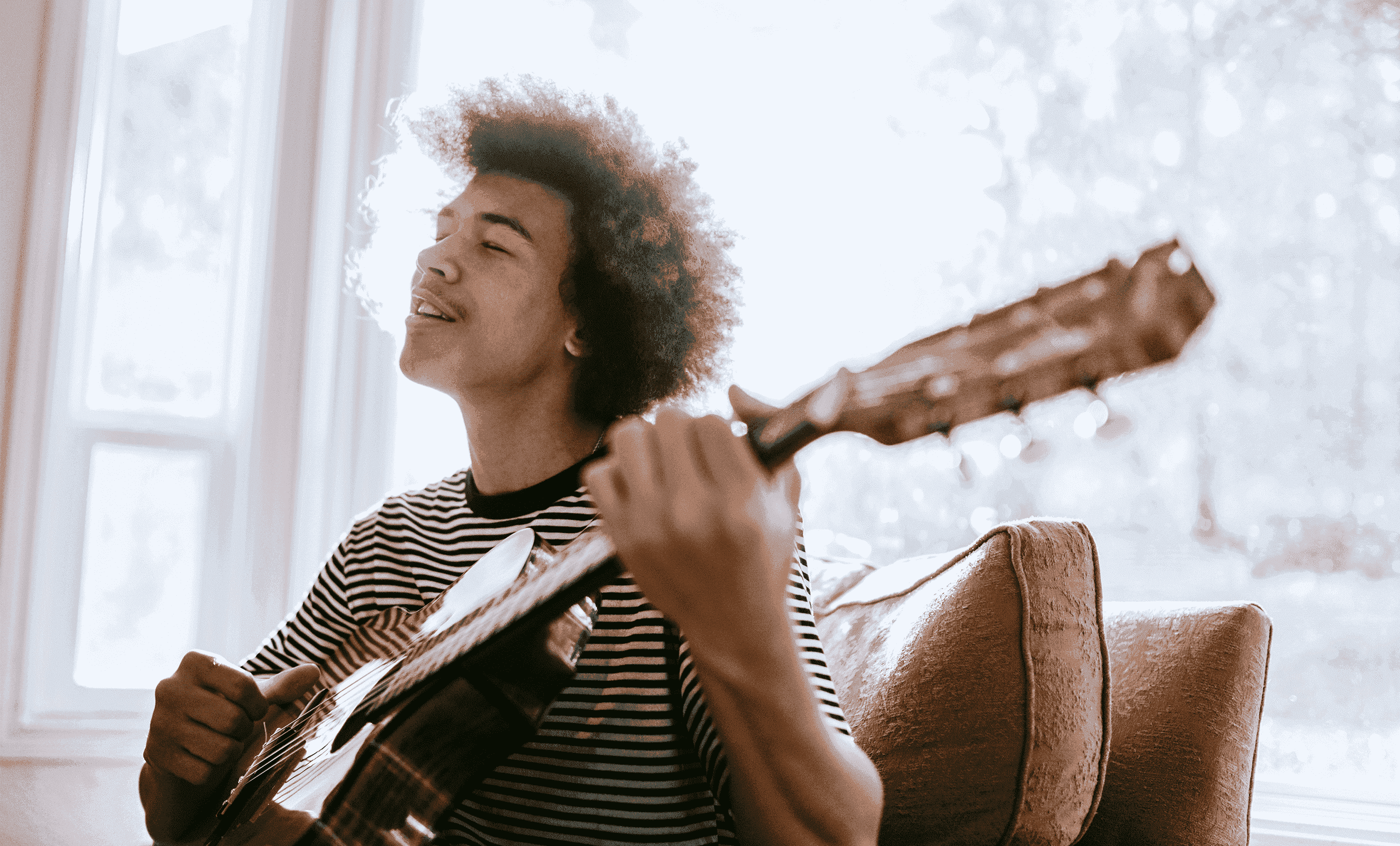 Person playing acoustic guitar