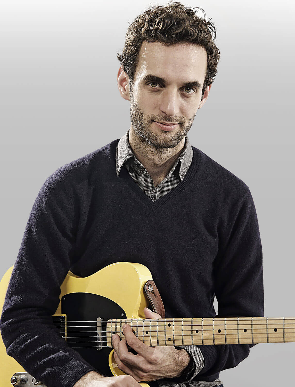 Julian Lage holding guitar
