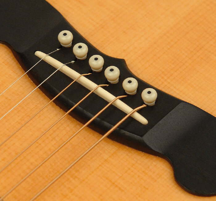bridge & end pins on a guitar