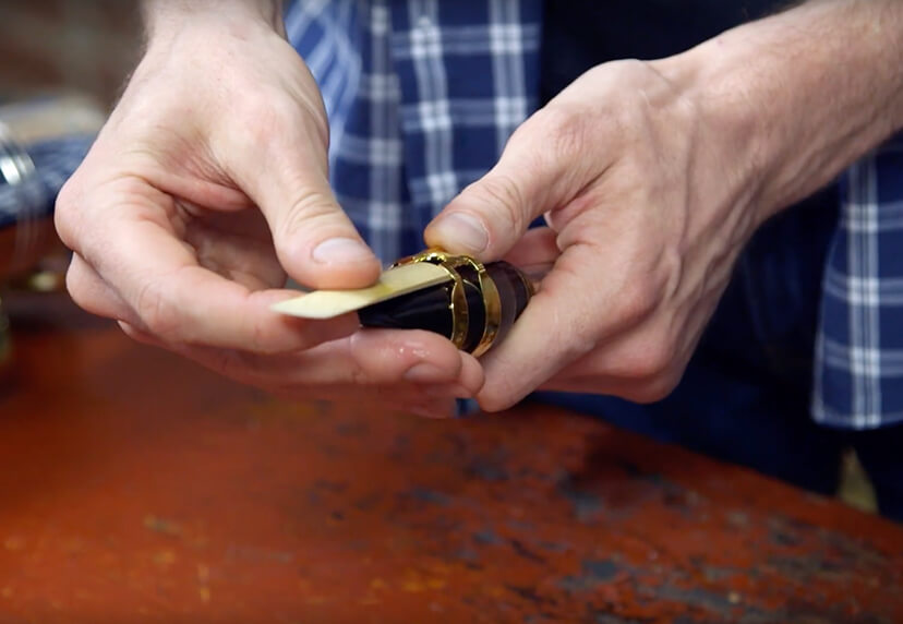 Person assembling a saxophone mouthpiece